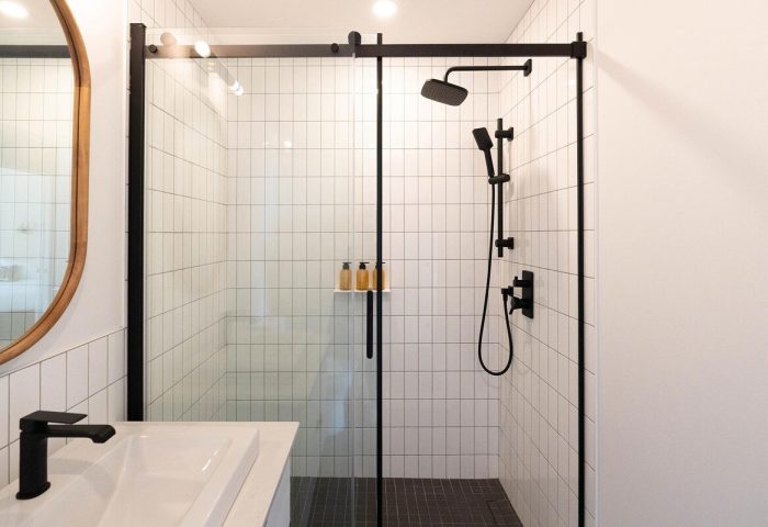 Maison Place Royale bathroom. Modern shower with black fixtures at this gay-friendly hotel by Luxury In Transit. Tile detail.