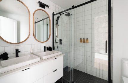 Maison Place Royale bathroom. Gay-friendly hotel by Luxury In Transit, features double sinks and a glass-enclosed shower.