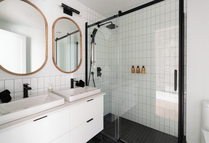 Maison Place Royale bathroom. Gay-friendly hotel by Luxury In Transit, features double sinks and a glass-enclosed shower.