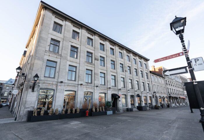 Maison Place Royale by Luxury In Transit, a gay-friendly hotel. Exterior view of the historic building in Montreal, Canada. Street view.