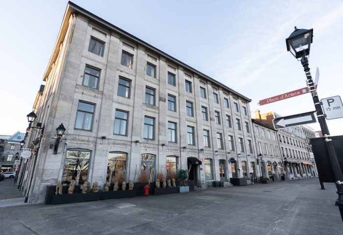 Maison Place Royale by Luxury In Transit, a gay-friendly hotel. Exterior view of the historic building in Montreal, Canada. Street view.