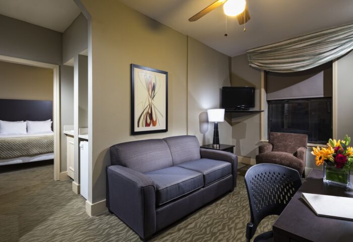 Majestic Hotel Chicago suite. Gay-friendly hotel room with sofa, bed, desk, and TV. Comfortable lodging for gay travelers in Chicago.