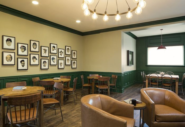 Majestic Hotel Chicago interior. Gay-friendly hotel with round tables, leather chairs, & framed portraits. A comfortable, stylish space.