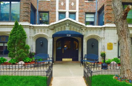 Majestic Hotel Chicago entrance. Gay-friendly hotel with a charming facade, benches, and well-manicured landscaping. Welcoming spot for gay travelers.