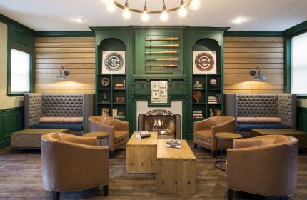 Majestic Hotel Chicago's gay-friendly lounge. Leather chairs, fireplace, and baseball decor create a cozy, inviting space.