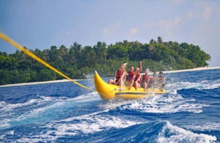 Banana boat fun at Malahini Kuda Bandos Resort! Gays enjoy water sports at this gay-friendly hotel in the Maldives.