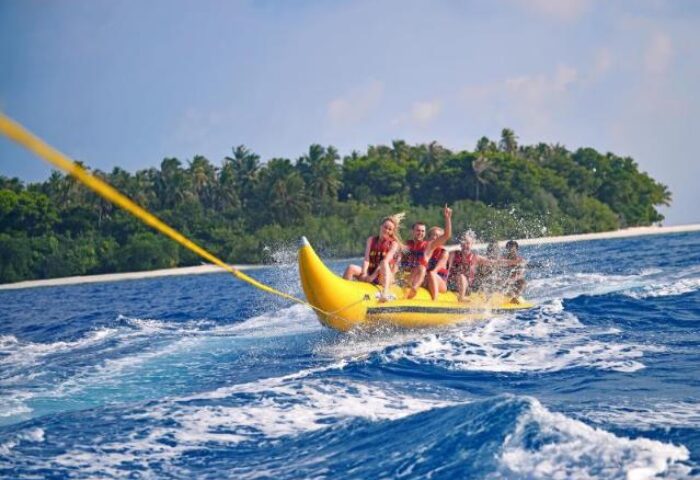 Banana boat fun at Malahini Kuda Bandos Resort! Gays enjoy water sports at this gay-friendly hotel in the Maldives.