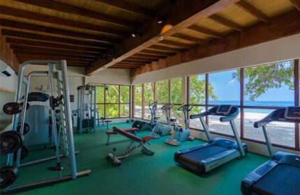 Malahini Kuda Bandos Resort gym. Gay-friendly hotel fitness center with treadmills, weights, and ocean view. Perfect for active gay travelers.