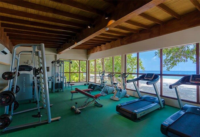 Malahini Kuda Bandos Resort gym. Gay-friendly hotel fitness center with treadmills, weights, and ocean view. Perfect for active gay travelers.
