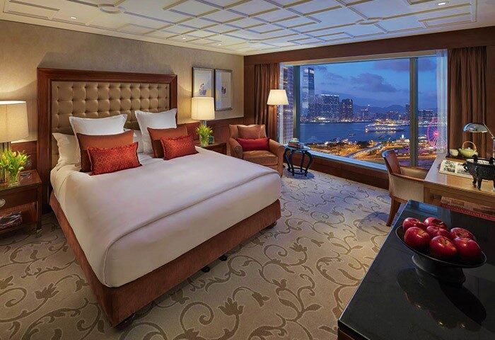 Gay-friendly Mandarin Oriental Hong Kong room. Luxurious hotel bedroom with Hong Kong city view. Gay travel advice.