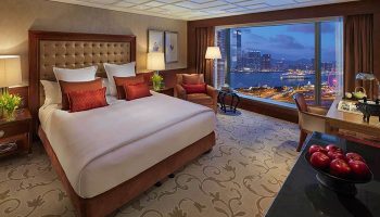 Gay-friendly Mandarin Oriental Hong Kong room. Luxurious hotel bedroom with Hong Kong city view. Gay travel advice.