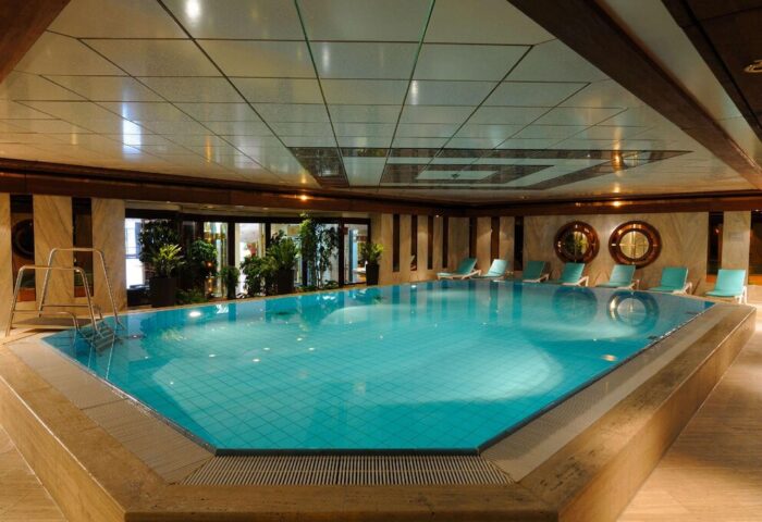 Indoor pool at Gay-Friendly Maritim Hotel Koeln. Relaxing leisure facilities for gay travelers. Loungers by the pool. Perfect for a gay vacation.