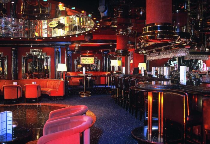 Gay-friendly Maritim Hotel Koeln bar. Red interior, mirrored ceiling, plush seating. A stylish spot in Cologne for LGBT travelers to enjoy.