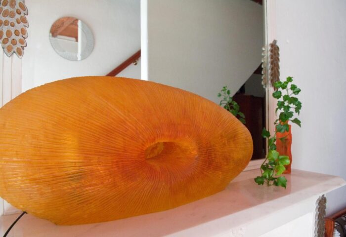 Matina Hotel, a gay-friendly hotel: Interior design detail with an orange lamp, a plant, and a mirror, creating a unique atmosphere.