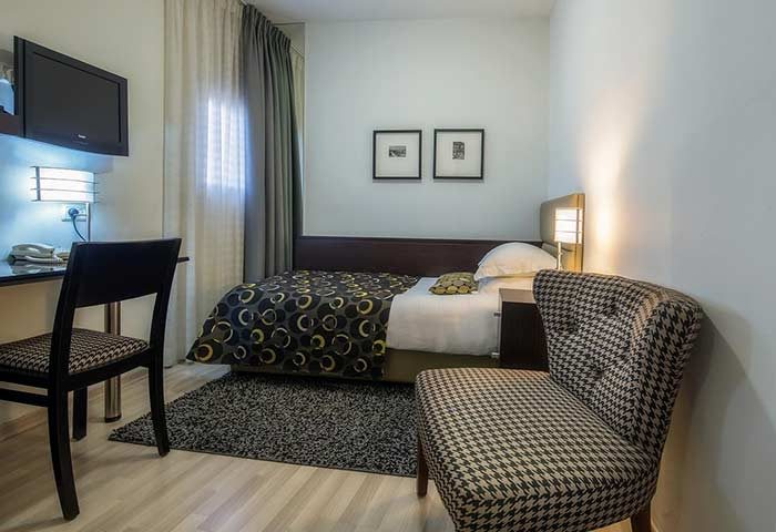 Maxim Design Hotel 3 Star Superior room. Gay-friendly hotel with bed, desk, chairs, tv, and modern design. Gay travel accommodations.