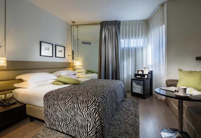 Gay-friendly Maxim Design Hotel 3 Star Superior room. Zebra print bedspread, modern decor, and a cozy, inviting atmosphere. Perfect for gay travel.
