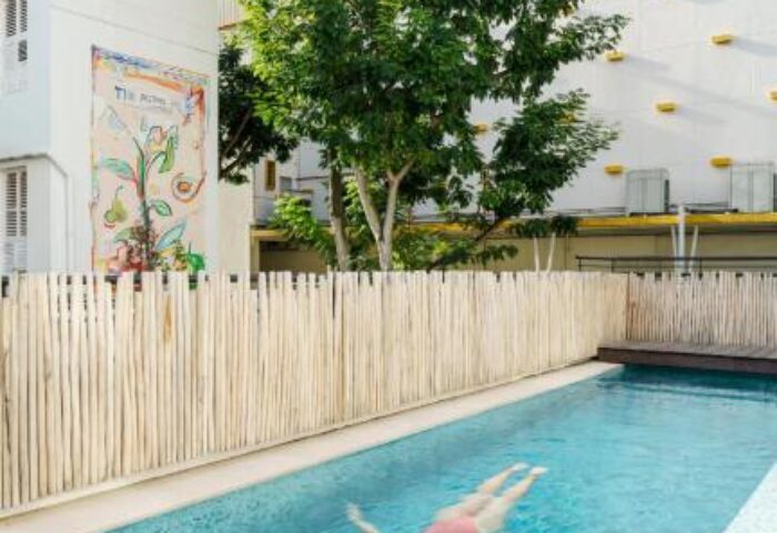 Maxwell Reserve gay-friendly hotel pool view. Woman swimming in the pool of this gay hotel. Great option for gay men travel advice.