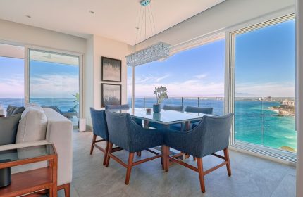 Maxwell Residences at Indah dining area with ocean view. Gay-friendly hotel offers luxury travel for gay men. Modern interior design.
