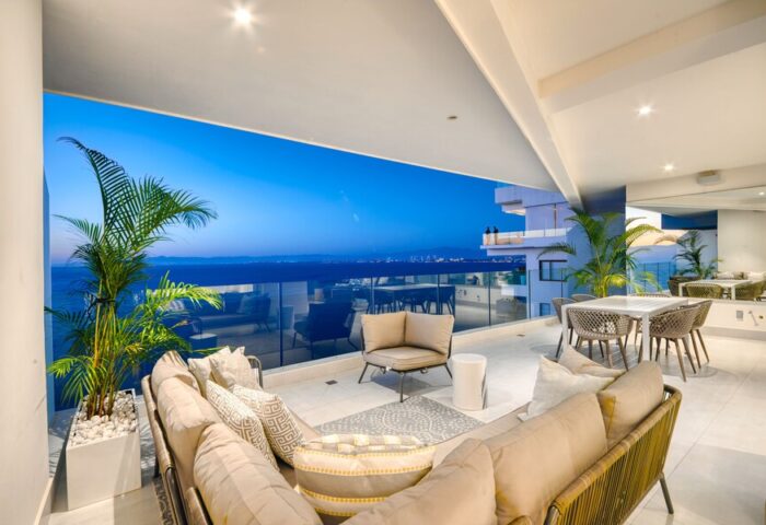 Maxwell Residences at Indah gay-friendly hotel balcony view. Outdoor seating, ocean vista. Ideal for gay men's travel. Luxury Indah stay.