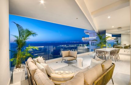Maxwell Residences at Indah gay-friendly hotel balcony view. Outdoor seating, ocean vista. Ideal for gay men's travel. Luxury Indah stay.