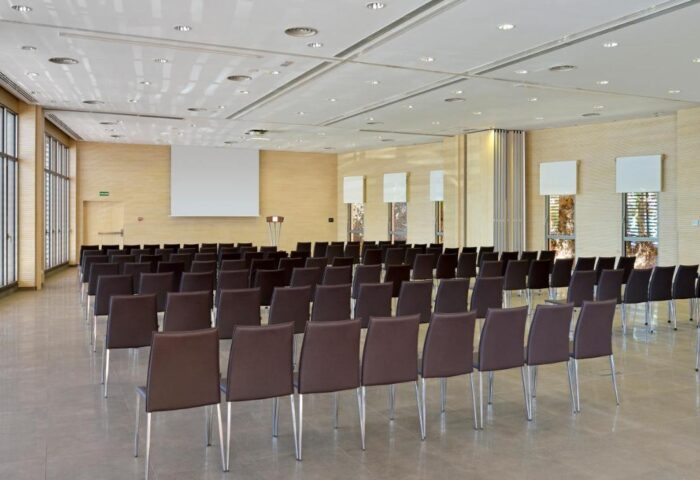 Melia Costa del Sol gay-friendly hotel conference room. Rows of chairs face a screen. Ideal event space for gay men's gatherings.