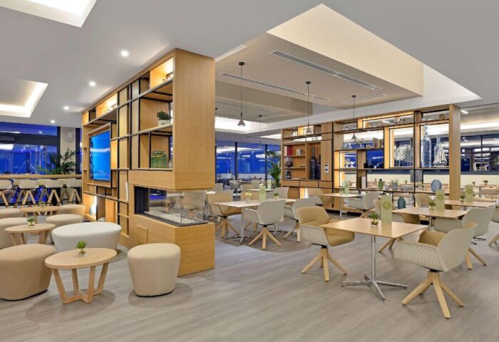 Melia Costa del Sol gay-friendly hotel restaurant. Modern interior with tables, chairs, and a decorative shelving unit. Inviting space for gay travelers.