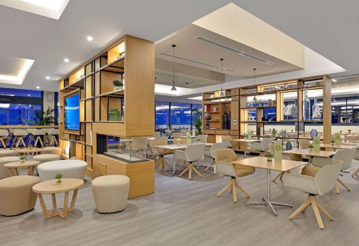 Melia Costa del Sol gay-friendly hotel restaurant. Modern interior with tables, chairs, and a decorative shelving unit. Inviting space for gay travelers.