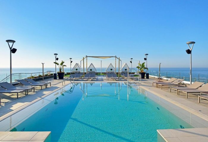 Melia Costa del Sol gay-friendly hotel rooftop pool. Lounge chairs, cabanas, and ocean views. A perfect gay travel destination.