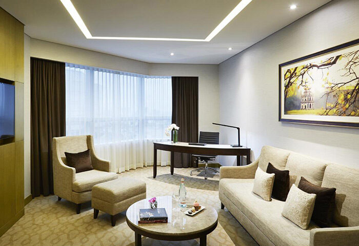 Melia Hanoi Hotel room. Gay-friendly hotel with modern decor, desk, sofa, and armchair. An ideal stay in Hanoi for gay travelers.