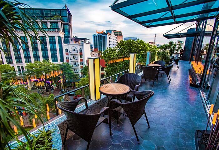 Rooftop terrace view at Gay-Friendly Melia Hanoi Hotel. Outdoor seating, city skyline. A perfect spot for gay travelers in Hanoi.