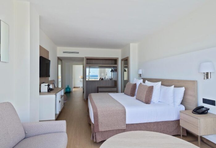 Melia Sitges gay-friendly hotel room. Modern decor, king bed, and partial ocean view. Perfect for gay travelers seeking comfort and style.