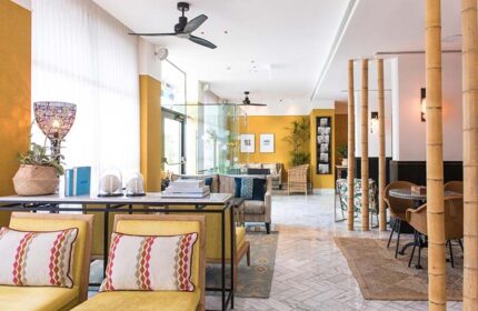 Melody Hotel, an Atlas Boutique Hotel: Stylish, gay-friendly hotel lobby with yellow walls, bamboo accents, and comfortable seating.