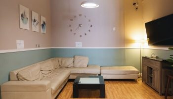 Melrose Hostel Adults Only lounge area. Gay-friendly hotel with comfortable seating, TV, and modern decor. Perfect for relaxing and socializing.