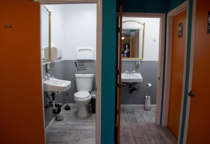 Melrose Hostel Adults Only gay-friendly hotel bathroom. Restrooms feature modern fixtures, clean design, and doors with male symbols.