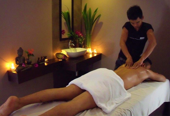 Man receiving a massage at a gay-friendly hotel spa. Relaxing treatment at a men's resort, promoting wellness and self-care for gay men.