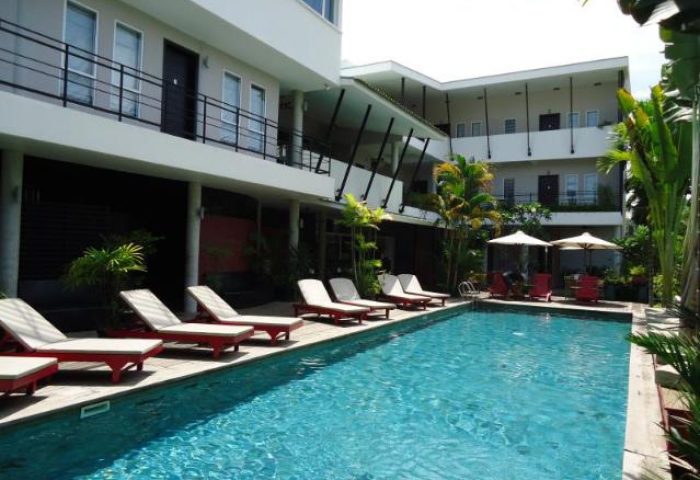 Men's Resort & Spa, a gay-friendly hotel. Swimming pool with lounge chairs. Tropical plants. Ideal for gay men's travel and relaxation.