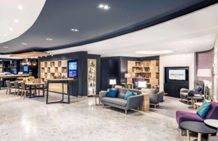 Mercure Budapest City Center Hotel lobby. Gay-friendly hotel with modern design, seating areas, tables, and a relaxed atmosphere. Perfect for gay travel.