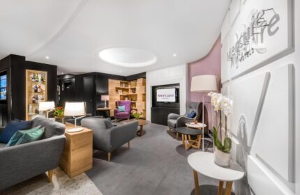 Mercure Budapest City Center Hotel lobby. Modern design, comfortable seating, TV, and stylish decor. Gay-friendly hotel in Budapest.