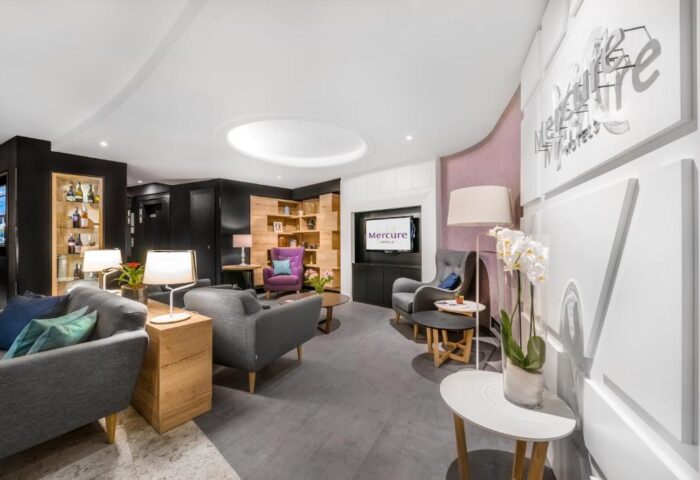 Mercure Budapest City Center Hotel lobby. Modern design, comfortable seating, TV, and stylish decor. Gay-friendly hotel in Budapest.