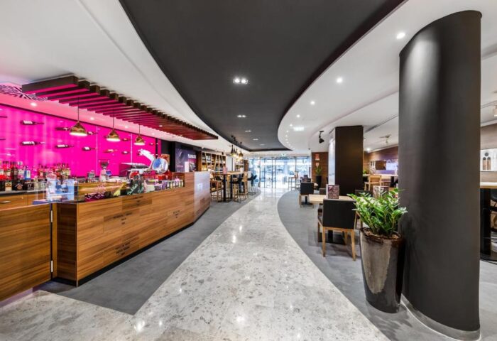 Mercure Budapest City Center Hotel's stylish lobby bar. Gay-friendly hotel with modern design, pink accents, and comfortable seating. #Budapest #Hotel