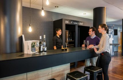 Bar at Gay-Friendly Mercure Hotel Berlin Zentrum. Guests enjoy drinks at the stylish bar with friendly service. Wine selection available.