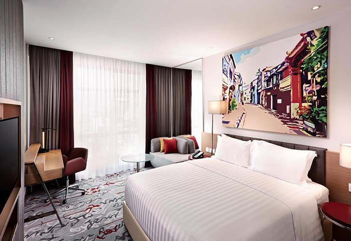 Mercure Kuala Lumpur Shaw Parade hotel room. Gay-friendly hotel with bed, desk, and colorful street art. Modern design for gay travelers.