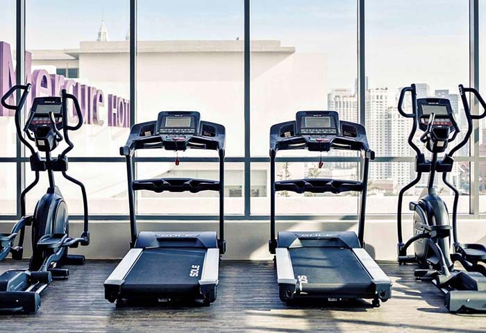 Gym at Gay-Friendly Hotel Mercure Kuala Lumpur Shaw Parade. Treadmills and elliptical machines with a city view. Fitness for gay travelers.