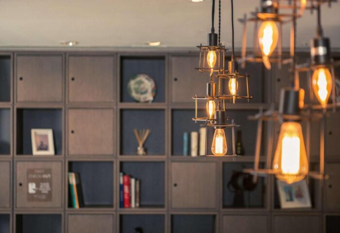 Interior of Gay-Friendly Mercure London Bridge Hotel. Edison bulb pendant lights hang in front of a cubby wall. Modern design.