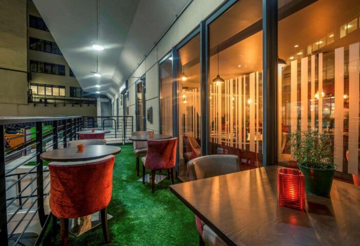 Mercure London Bridge gay-friendly hotel outdoor terrace. Tables, chairs, and artificial grass create a welcoming space for LGBTQ+ travelers.