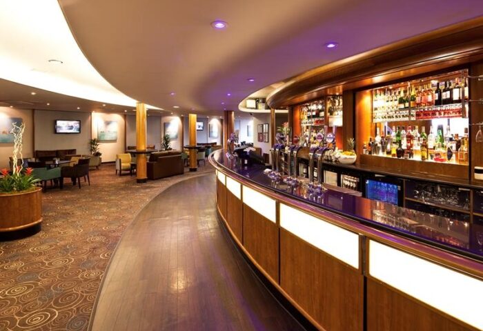 Interior of the Gay-Friendly Mercure Manchester Piccadilly Hotel bar. A well-stocked bar and lounge area offer a welcoming space.