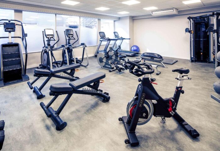 Gym at Mercure Manchester Piccadilly Hotel, a gay-friendly hotel. Exercise equipment includes treadmills, bikes, elliptical trainers, & weights.