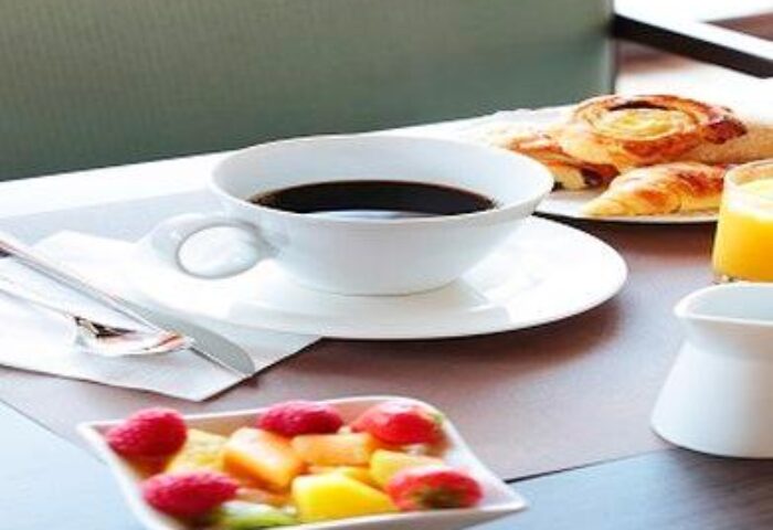 Breakfast at Mercure Manchester Piccadilly Hotel. Coffee, pastries, juice, and fruit. Gay-friendly hotel stay in Manchester, UK.