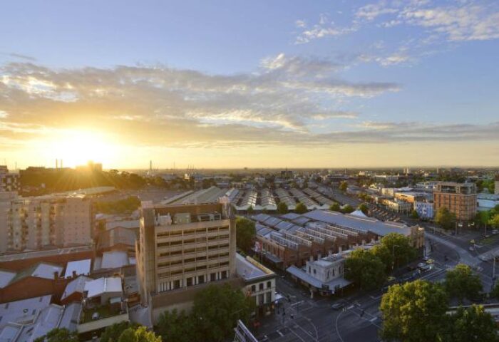 Melbourne skyline at sunset. View from gay-friendly Mercure Melbourne Therry Street hotel. Cityscape with buildings, streets, and sky.