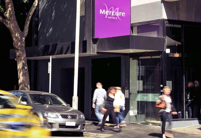 Mercure Melbourne Therry Street, a gay-friendly hotel. Exterior view of the hotel entrance with people walking by. Melbourne hotel near gay bars.